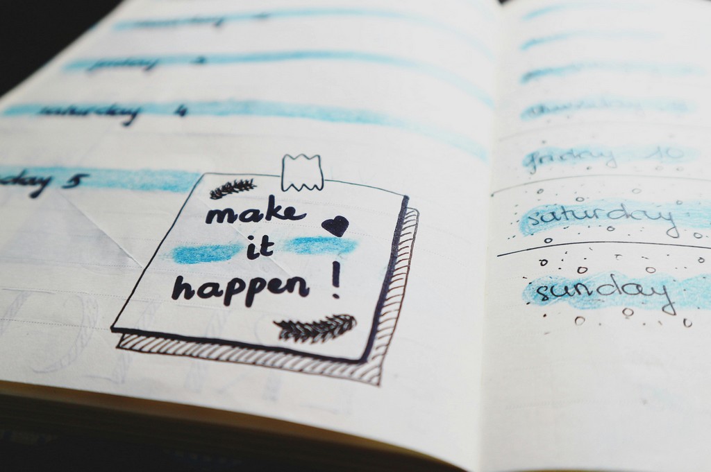 A notepad shows the text Make it Happen.