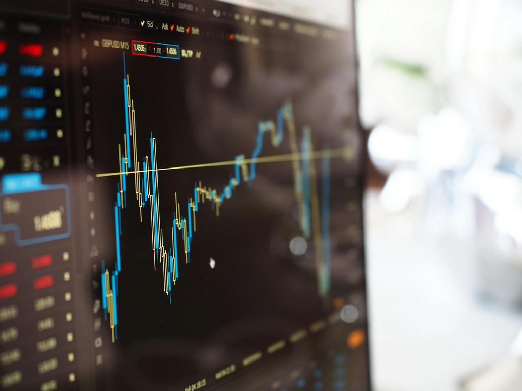 A screen shows financial charts.