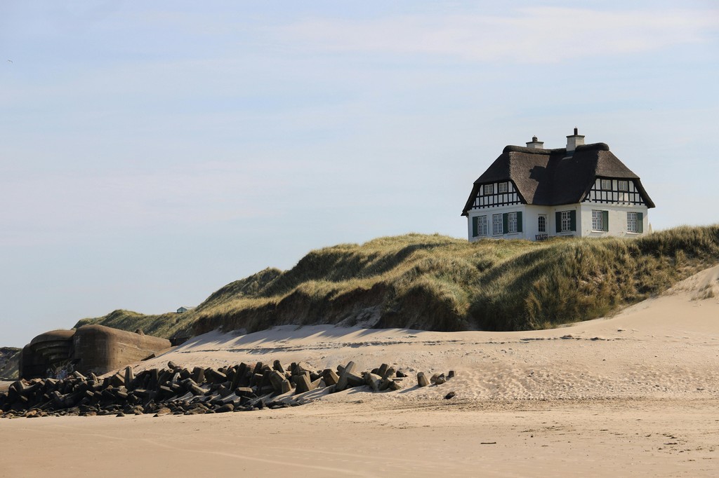 A solitary house overlooks the coastline.