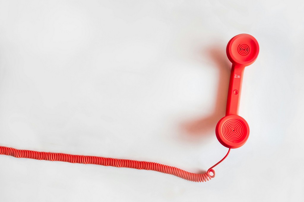 A red phone line is laid out on the table.