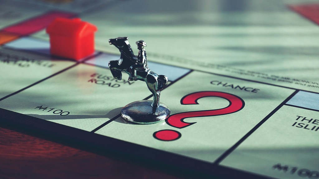 A Monopoly piece lands on the Chance square.